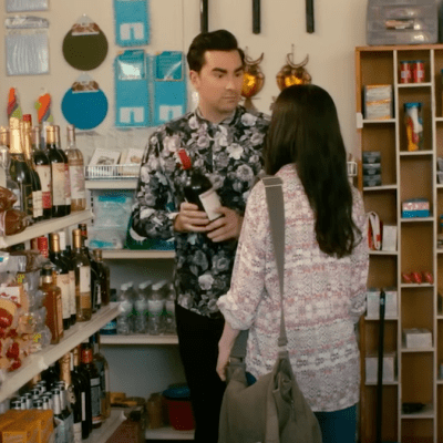 David Rose (Dan Levy) peruses the wine aisle in Schitt's Creek.