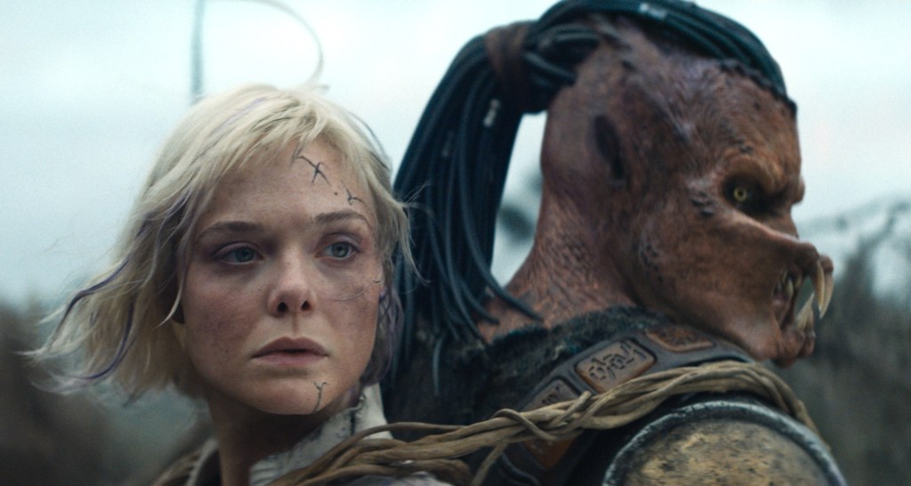 Elle Fanning and Predator in Predator: Badlands