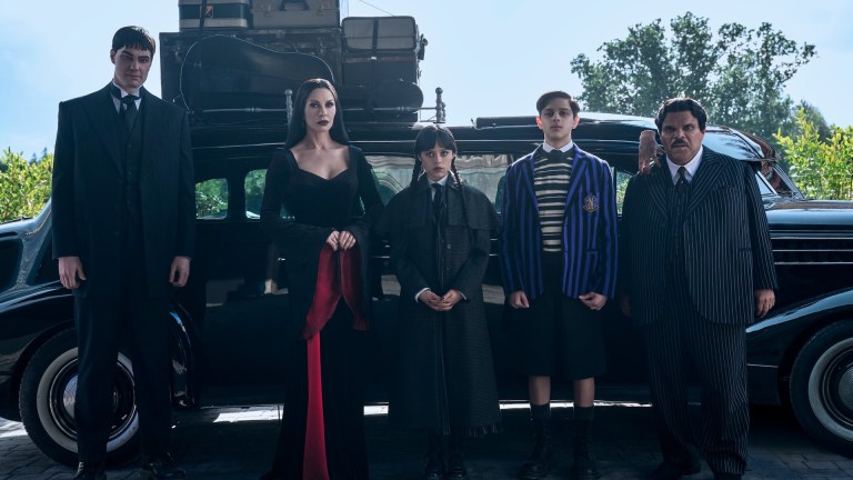 Wednesday. (L to R) Joonas Suotamo as Lurch, Catherine Zeta-Jones as Morticia Addams, Jenna Ortega as Wednesday, Isaac Ordonez as Pugsley Addams, Thing, Luis Guzmán as Gomez Addams in episode 201 of Wednesday.