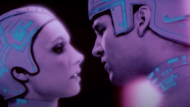 An image of Jeff Bridges about to kiss a lady inside a computer from Tron.