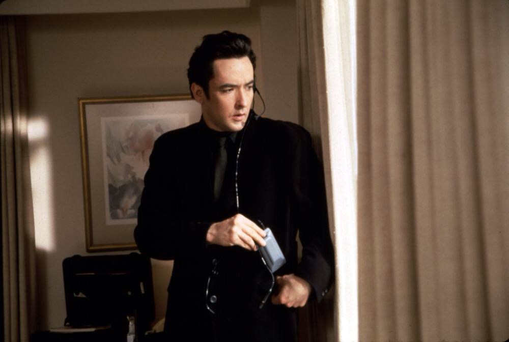 John Cusack perfectly embodies the quirky hitman comedy vibe.
