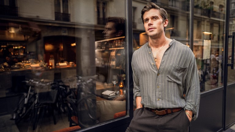 Antoni Porowski leans against the window at FIEF restaurant. (National Geographic/Amy Browning)