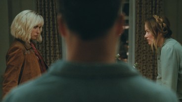 I’m not going to begin by stating emphatically that Penelope Cruz and Edward Norton play sexy-time ghosts in Olivia Wilde’s The Invite… but what if they might be ghosts, who happen to be sexy? I’m joking, but also stay with me for a minute. Still high off its buzzy premiere at Sundance, The Invite walks, blurs, and utterly dissolves all manner of boundaries and bougie festival taboos. Floating with an ethereal mystique that borders on the occult, as well as a painfully hilarious naturalism, this is a movie that orbits around a marriage in midlife catastrophe to the point of dizziness—an even more impressive feat after the film was marketed with such deceptive seduction. To be sure, Cruz and Norton are quite appealing, the seemingly perfect couple upstairs in a posh, if ancient, New York City tenement building. They initiate friendly conversation in the elevator, look gorgeous while making preternatural eye contact with neighbors, and apparently have passionate, earth-shattering sex after midnight each evening. Angela and Joe (Wilde and Seth Rogen) should know. They hear it every night through their ceiling, along with a 12-year-old daughter who is never seen in the film. There is something just otherworldly about Piña and Hawk (Cruz and Norton). And it leaves our central couple so alternatingly resentful and envious that the movie begins with an insert card of an Oscar Wilde quote: the eternal harbinger of doom for any romantic sentimentality beyond skin-deep nihilism. So when Joe and Angela invite Piña and Hawk over for a couple’s dinner, something aloof is in the air. Joe thinks it’s tension, as he is more than ready, eager even, to complain about the animal sounds through the floorboards. But for our spirited guests, the tension could have an entirely different flavor, one of suspense as they are here to—eventually—propose the downstairs stuffed shirts join them in a shared sexual experience. They want to swing by switching spouses for the night. The ghostly element I mentioned earlier is a bit of a come-on, but not by much. While the film quotes Wilde, Oscar, there’s more than a touch of Dickens and his descendants about the way Piña and Hawk float into our unhappy protagonists’ lives. They’re kinky Jacob Marleys, freaky Clarences, the angel of mercy in It’s a Wonderful Life who’s come to grant Jimmy Stewart a second chance at life after decades of disappointment by getting frisky in the kitchen. Even the audience is tempted into thinking they’re watching one kind of beguiling sex comedy, which we kind of get, even as we’re really being lured into a far more existential exploration of love and marriage after the romance has died. Are things not already in the Twilight Zone when an orgy invite from strangers amounts to the closest thing to high romance Joe or Angela’s heard in years? The trick of Olivia Wilde’s film and its inviting screenplay by Rashida Jones and Will McCormack is its structure. Based on the Spanish film The People Upstairs, Wilde’s picture borrows the original’s real-time setting of an unwieldy night of collapsing inhibitions and glasses of wine giving way to low-lit confessions in a cozy apartment’s corners. Among Jones and McCormack’s many scripted innovations, however, is the sensation that this is occurring in a bit of a theater workshop. This isn’t a knock at the performances, which are excellent, but at the sense we are sitting with a group of professionals, also over wine, as they psychoanalyze and deconstruct a messy, impermanent thing: the marriage of two people who care for each other but lost love a long time ago. Wilde shoots the film almost wholly in steadicam and in an underlit setting wherein the decorative paint colors and apartment accoutrements that Angela distracts herself with are indistinguishable. She isn’t wrong to note Joe is checked out when she talks about “finishing” the bedroom several years on, but Wilde the filmmaker cannot let her character hide behind minutiae. She drowns Angela and Joe’s faux domesticity into an inviting yet gloomy shadow world. Similarly, the helmer constantly films Rogen’s Joe as a domineering force in the life of his wife, towering over the frame and shot in harsh low light like a Halloween fright mask. At other times, the pair are caught in line of sight of each other in their horseshoe-shaped apartment, with the duo able to simply look up across the way and see one another in parallel windows. Yet they never do. It would make eye contact and break the spell of mutually agreed upon isolation. At its core, though, one does not cast a talent like Rogen, or for that matter Wilde at her most mischievous, and not revel in the humor. Rogen accentuates a new note of tired resignation to his likable, schlubby everyman persona, but there’s a lot more bitterness to Joe than Matt Remick in The Studio, as well as more pathos. This is a sad sack too self-involved to recognize he’s dragging his marriage down, but his unhappiness is not unsympathetic to anyone who reached a certain point in life where they realized they did not become the person they dreamed about when they were 20. It also makes his acerbic digs at Piña and Hawk, particularly for the latter’s clearly self-chosen name, all the more biting. Meanwhile Cruz delights in her role that purposefully walks a line between the ethereal and earthy. For much of the film, she might be a cipher, or certainly a projection of Joe and even Angela’s desires, albeit in very different contexts, but Cruz plays it with a rueful self-awareness. She’s the cat plucking at a pair of wounded canaries’ wings. The scene where she specifically attempts to uncoil Joe out of his wound-up funk to Sade’s now 26-year-old(!) “By Your Side” is a harmonious car crash; a collision of sweetness and cringe, reverie and gallows humor despair. And I haven’t even mentioned his “dance” moves. The Invite is a shimmering dramedy for adults of a certain age, and perhaps a sobering epiphany that this can now be so acutely tailored to elder Millennials and younger Gen-Xers at that. The film is genuinely sexy but in the awkward and disarming way of clumsy foreplay. It stumbles and stammers, with its proverbial pants caught around the ankles before the whole thing tonally keels over. Yet for all the screenplay’s verbose intellectualization about sensuality, and Wilde’s obvious preoccupation with it as a storyteller, the main event is something more intimate and unspoken. It’s a lament about the passage of time, milestones left discarded, and maybe even marriages that also have outlived their shelflife. One might even call it haunting, complete with the mysterious good-looking specters descending from above. Penelope Cruz and Olivia Wilde in The Invite Review