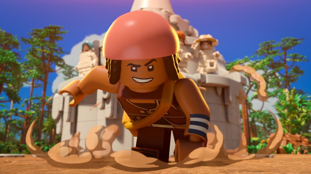 "LEGO character in dynamic running pose, wearing a helmet and armband, stirring up dust in a bright outdoor jungle setting with a large stone monument and trees in the background."
Lego One Piece S1. Jacob Romero as Usopp in Lego One Piece S1. Cr. Courtesy of Netflix © 2026
