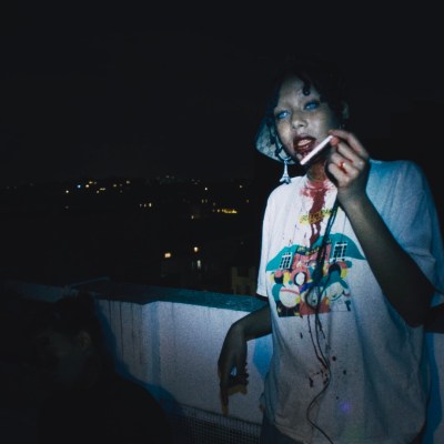 A chic young vampire holding a cigarette in the film I Love Paris