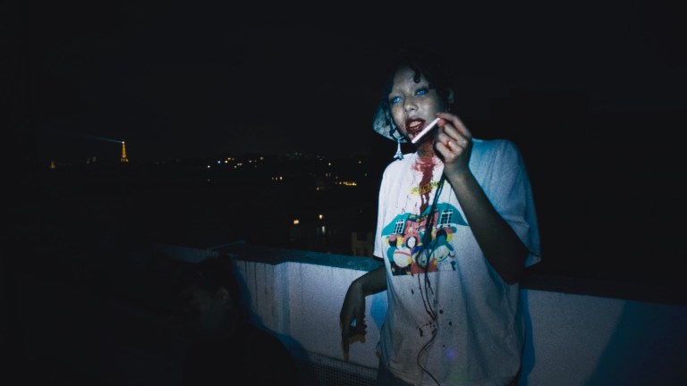 A chic young vampire holding a cigarette in the film I Love Paris